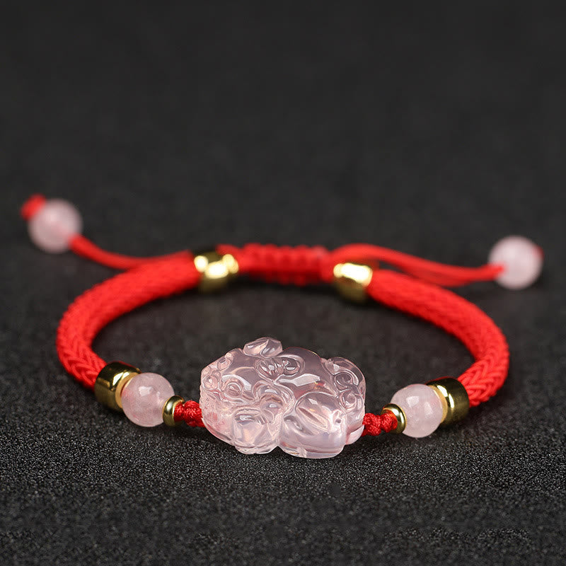Pink Crystal PiXiu Bracelet – Front view of pink crystal PiXiu on red cord with gold bead accents