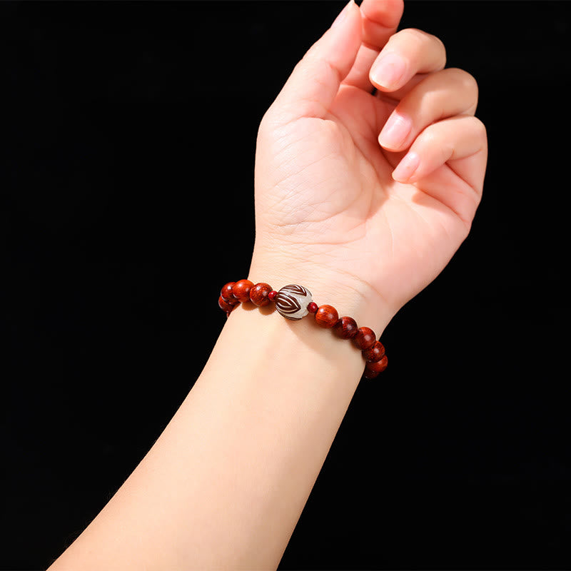 Rosewood Cyan Jade Bodhi Lotus Bracelet - carved lotus bead on wrist, black background, Warmth