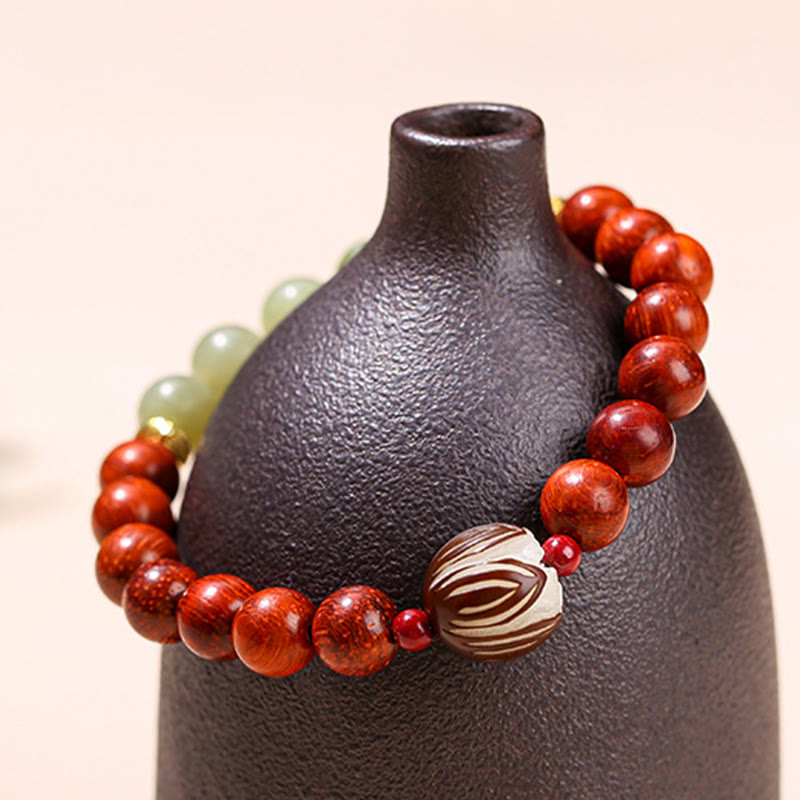 Rosewood Cyan Jade Bodhi Lotus Bracelet - draped on black ceramic vase, Warmth
