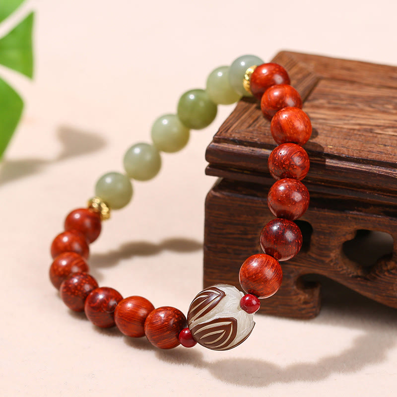 Rosewood Cyan Jade Bodhi Lotus Bracelet - carved lotus focal on wooden stand with leaves, Grounding