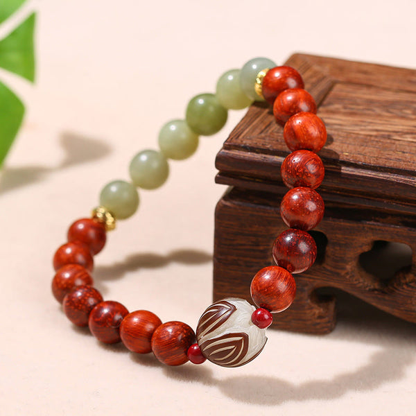Rosewood Cyan Jade Bodhi Lotus Bracelet - carved lotus focal on wooden stand with leaves, Grounding