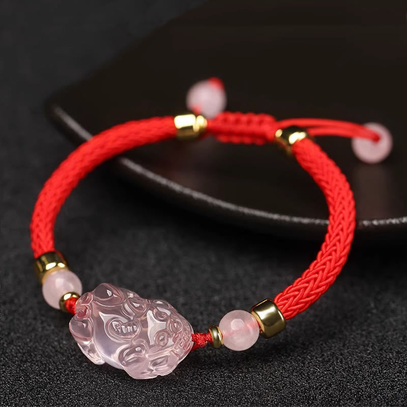 Pink Crystal PiXiu Bracelet – Red braided bracelet with PiXiu near black ceramic plate