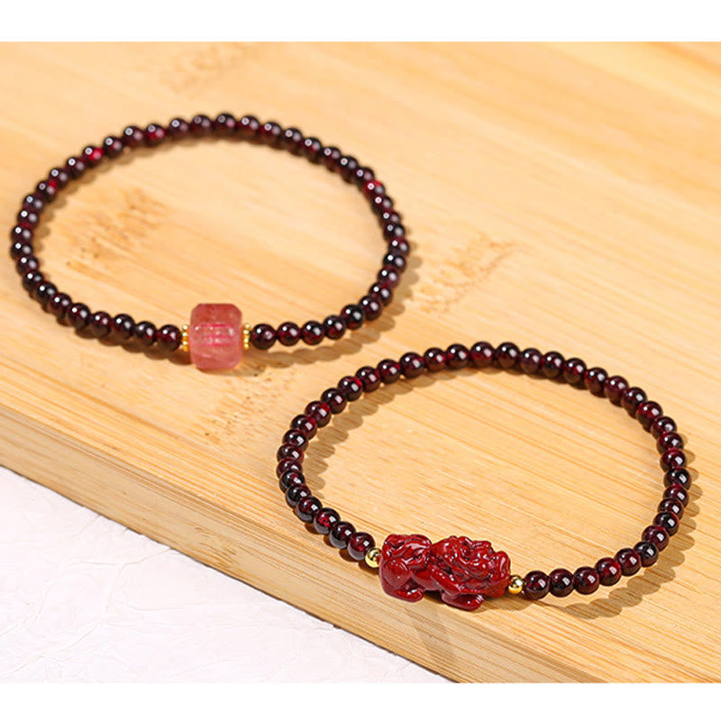 Garnet Cinnabar PiXiu Bracelet – two bracelets on light wood surface passion love set, garnet jewelry