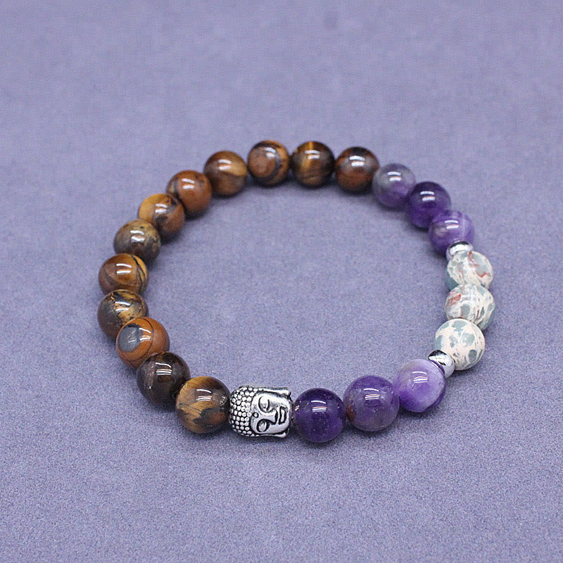 Mixed Gemstone Buddha Head Bracelet – on rustic wooden table with incense stick, meditation altar setting