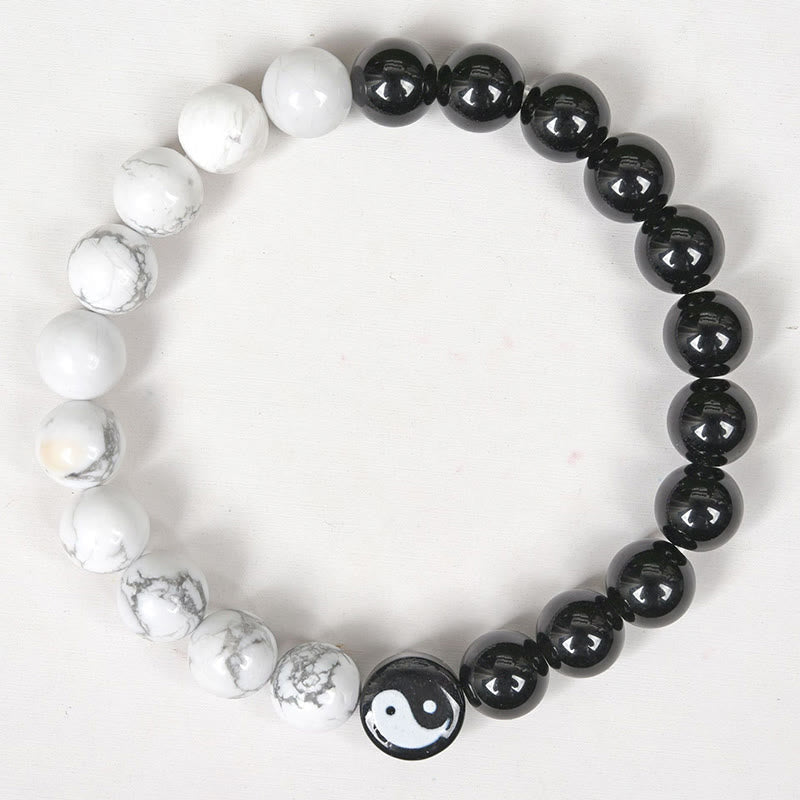 Obsidian White Turquoise Yin Yang Bracelet - top-down flat lay of black obsidian and white turquoise bead bracelet with yi...
