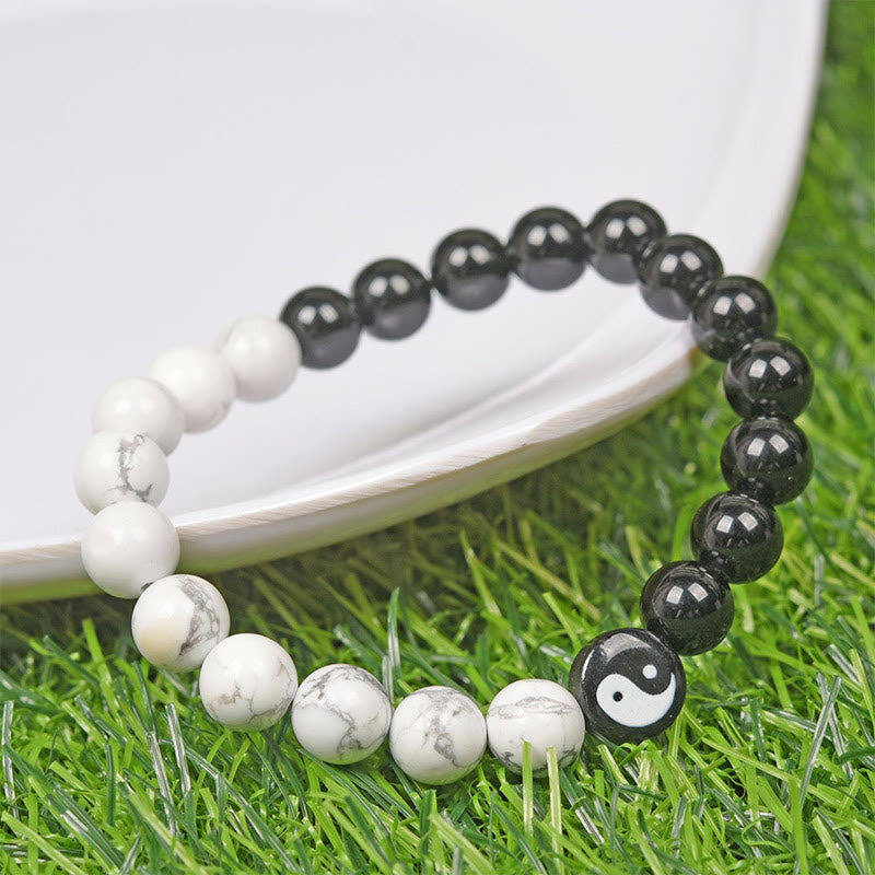 Obsidian White Turquoise Yin Yang Bracelet - beaded yin-yang bracelet with obsidian and turquoise on green grass, spiritua...