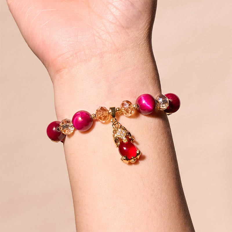 Red Tiger Eye PiXiu Bracelet – Worn on wrist against beige background, confidence balance jewelry