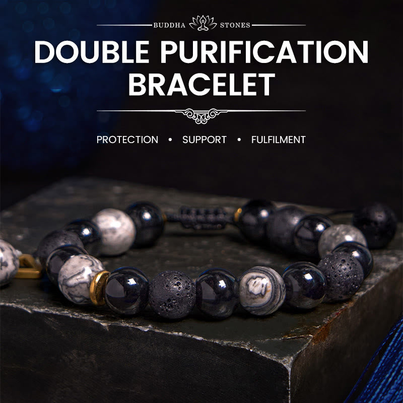 Black Obsidian Lava Rock Yin Yang Bracelet - moody styled shot with BUDDHA STONES branding, dark blue backdrop