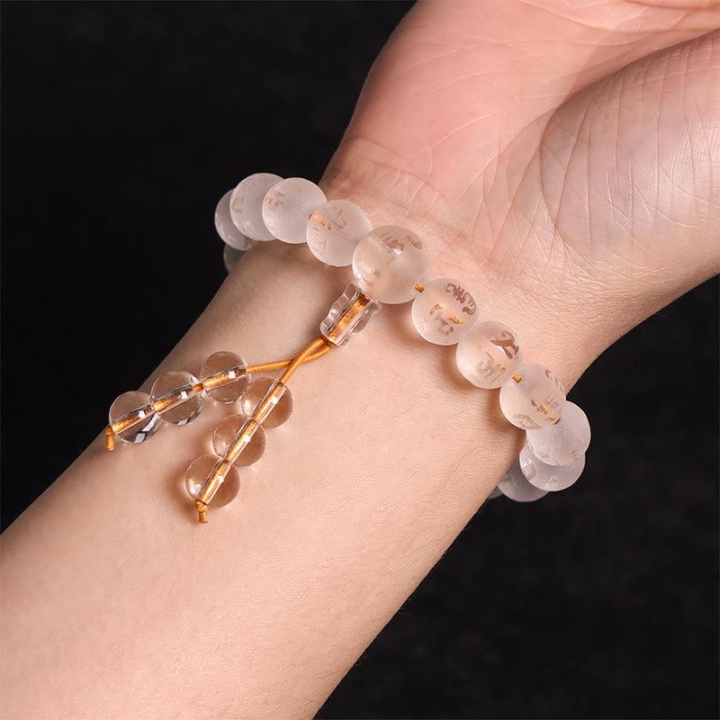 White Crystal Mantra Bracelet – Worn on wrist showing frosted bead fit and tassel detail