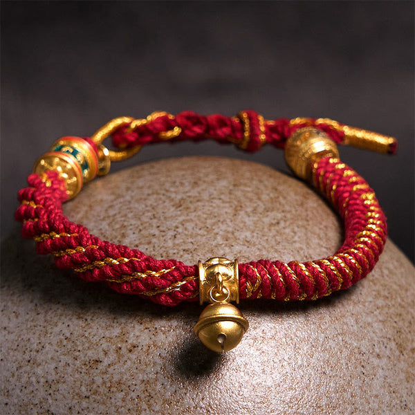 Zakiram Om Mani Padme Hum Charm Bracelet – Resting on natural pebble with enamel bead detail, woven charm bracelet