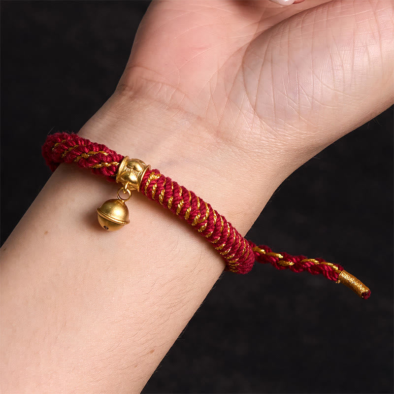 Zakiram Om Mani Padme Hum Charm Bracelet – Worn on wrist showing red gold braid fit, black background detail shot