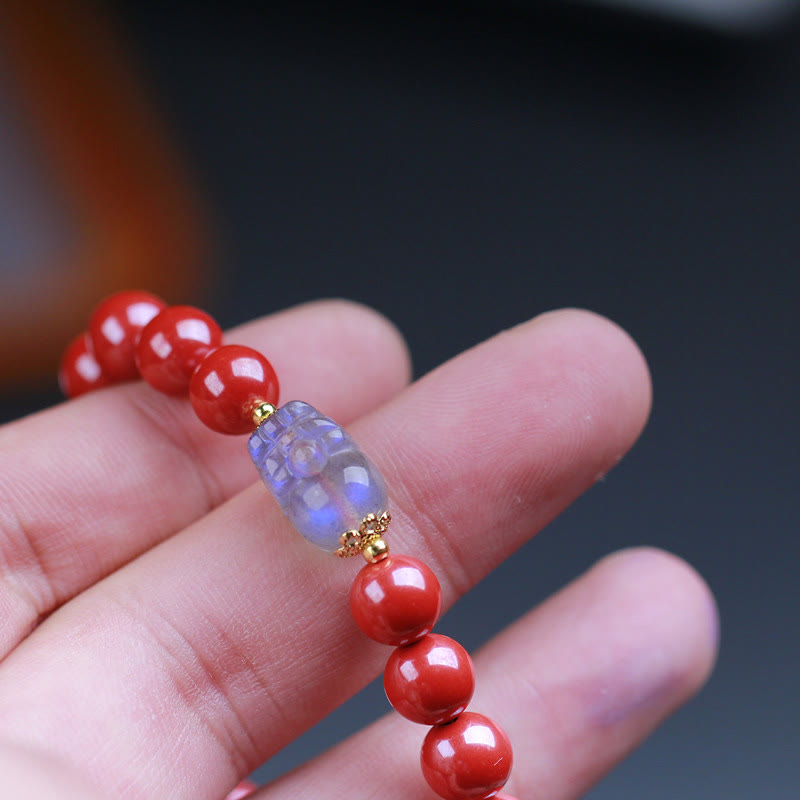 Cinnabar Moonstone PiXiu Bracelet – Hand holding bracelet moonstone PiXiu detail, craftsmanship