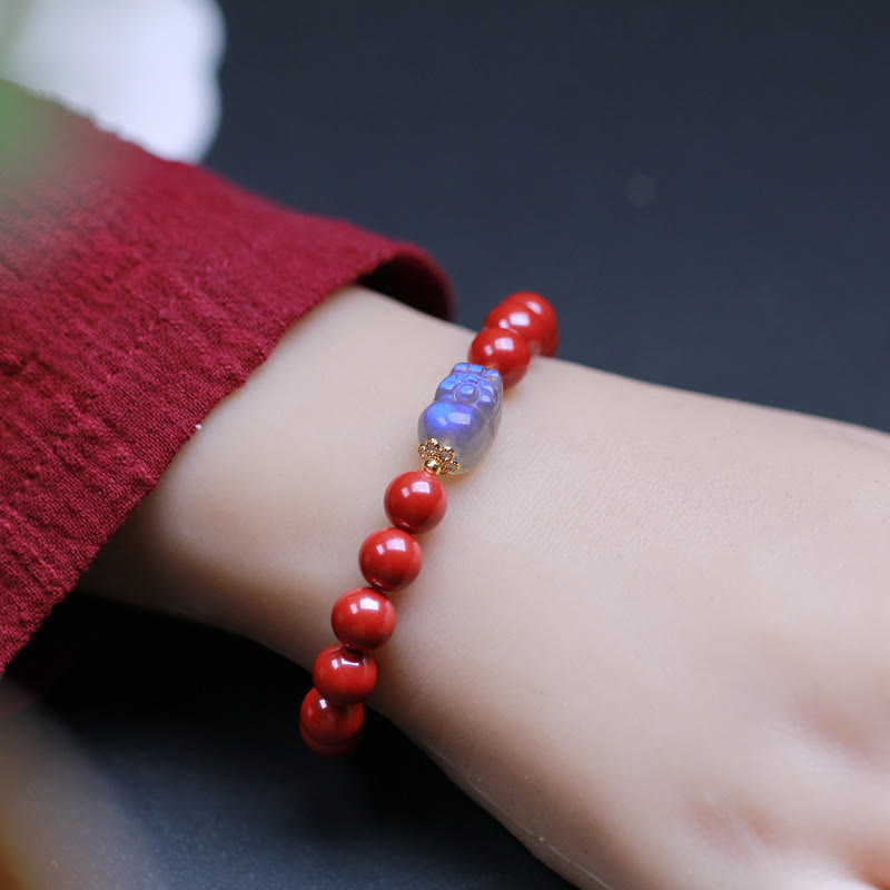 Cinnabar Moonstone PiXiu Bracelet – Wrist wearing red cinnabar bracelet red sweater, cozy style