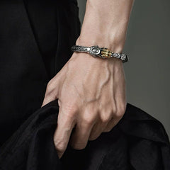 Sterling Silver PiXiu Coins Bracelet – Male hand with silver PiXiu bangle holding fabric, bold accessory