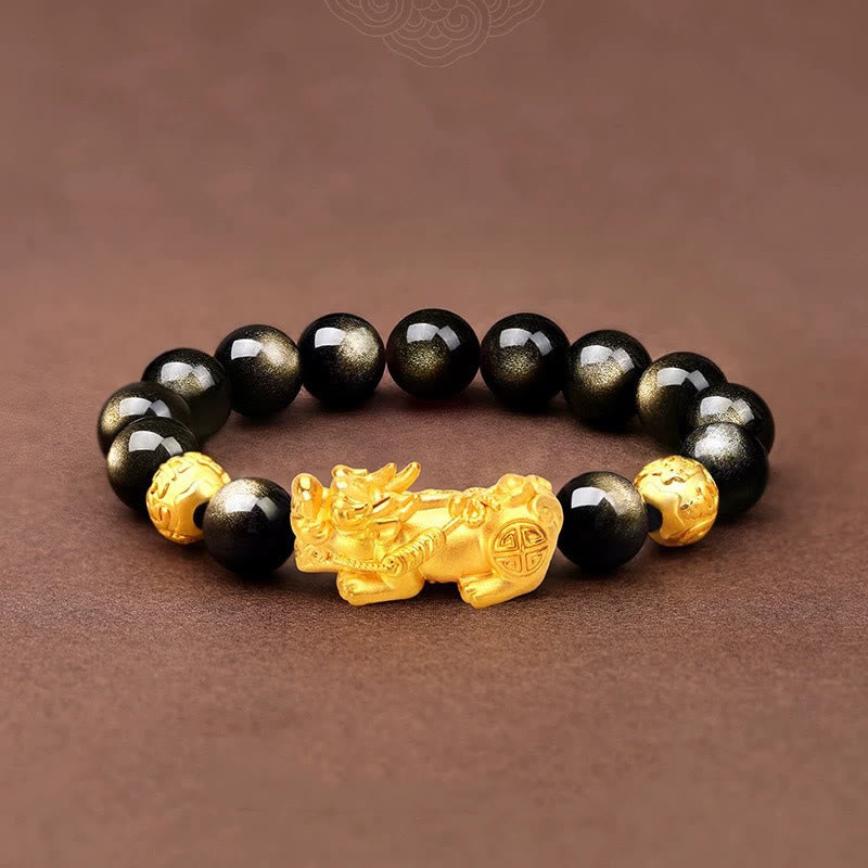 Gold Sheen Obsidian PiXiu Bracelet – Flat lay black beads with gold PiXiu on brown fabric, men wealth