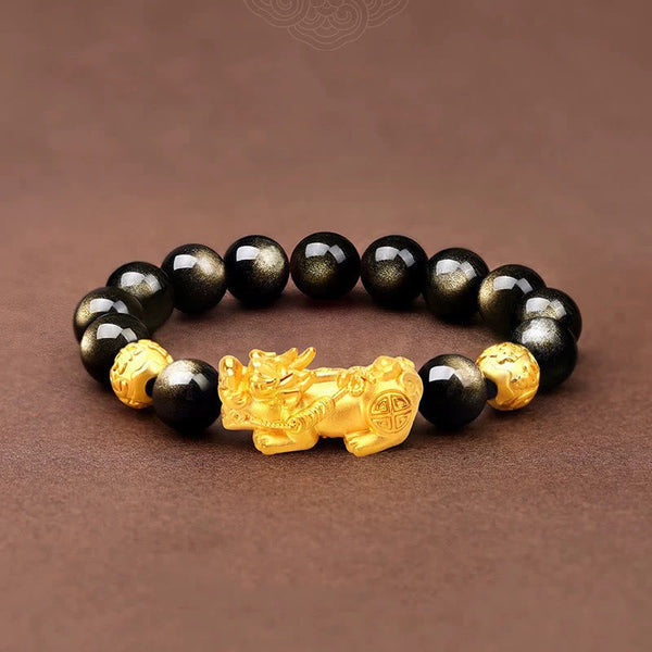 Gold Sheen Obsidian PiXiu Bracelet – Flat lay black beads with gold PiXiu on brown fabric, men wealth