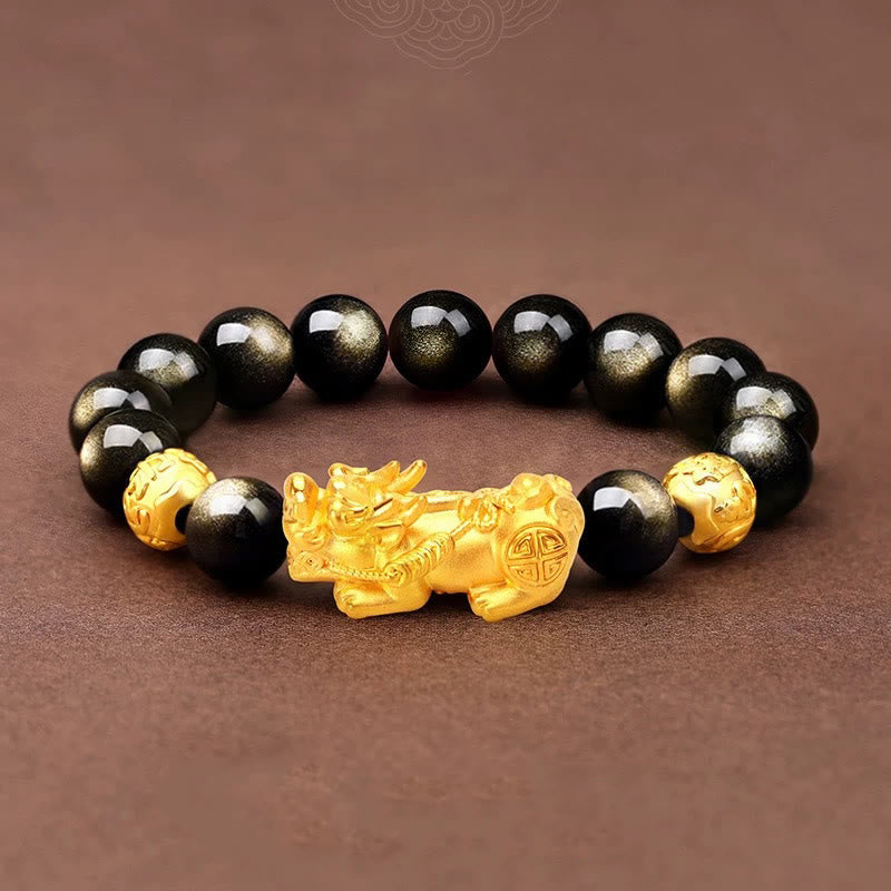 Gold Sheen Obsidian PiXiu Bracelet – Black beads with gold PiXiu on brown surface, prosperity bracelet
