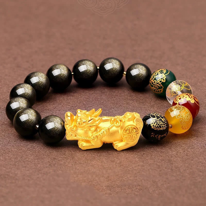 Gold Sheen Obsidian PiXiu Bracelet – flat lay on brown fabric, gold PiXiu detail, multicolor accent beads