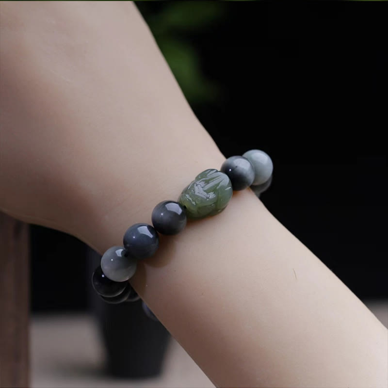 Eagle's Eye Jade PiXiu Bracelet – dark gray bracelet worn on wrist, green PiXiu charm, confidence jewelry