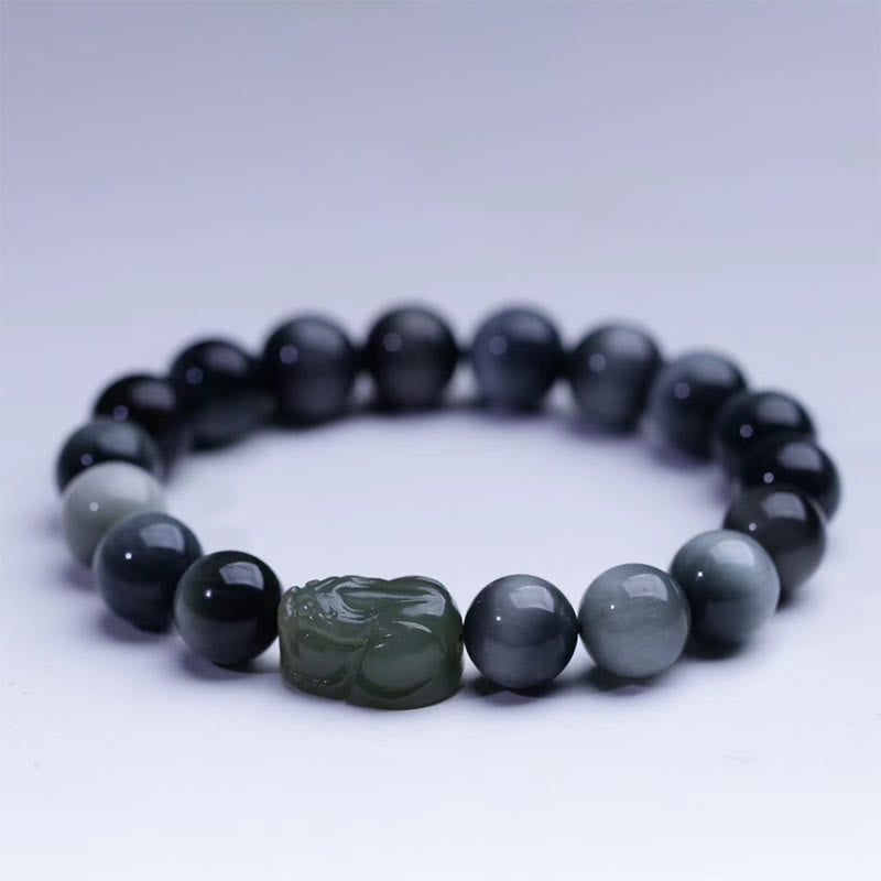 Eagle's Eye Jade PiXiu Bracelet – studio shot on white background, gray-blue beads with green PiXiu, clean