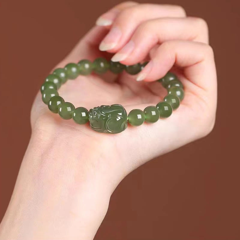 Hetian Jade PiXiu Bracelet – deeper green jade variant on wrist, brown background, harmony bracelet