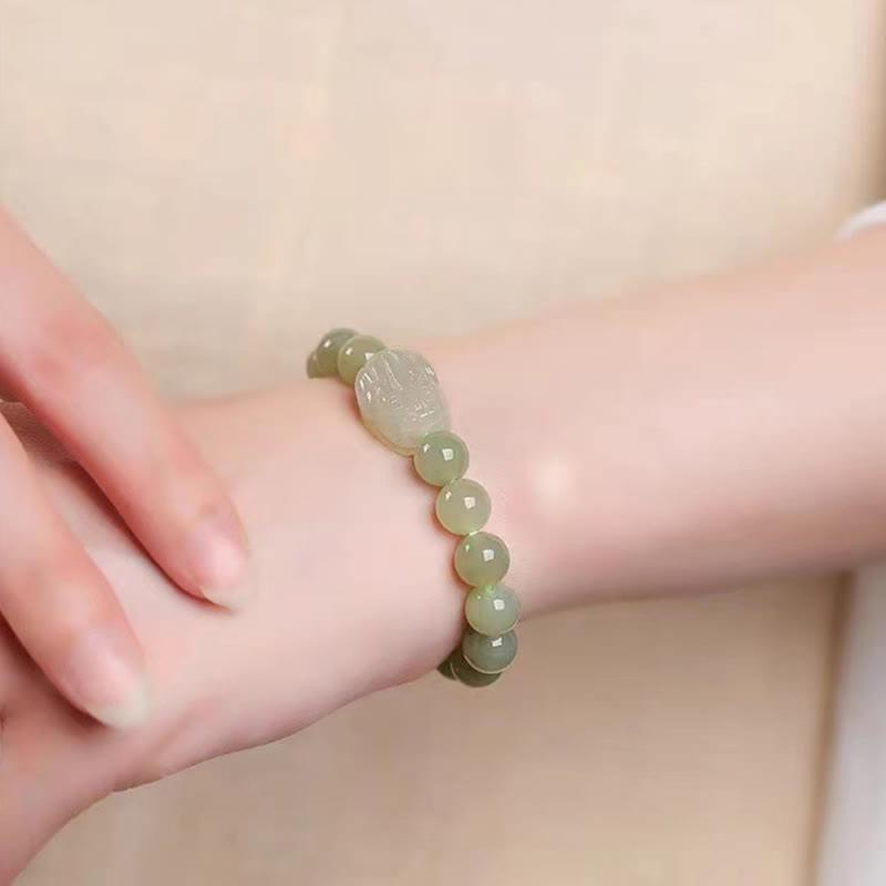 Hetian Jade PiXiu Bracelet – pale green jade bracelet on wrist, hand adjusting, elegant wear shot