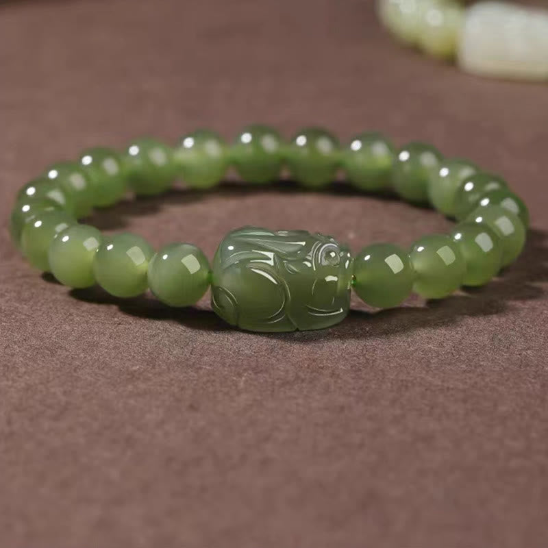 Hetian Jade PiXiu Bracelet – deep green jade beads with PiXiu on brown fabric, rich color, luck charm