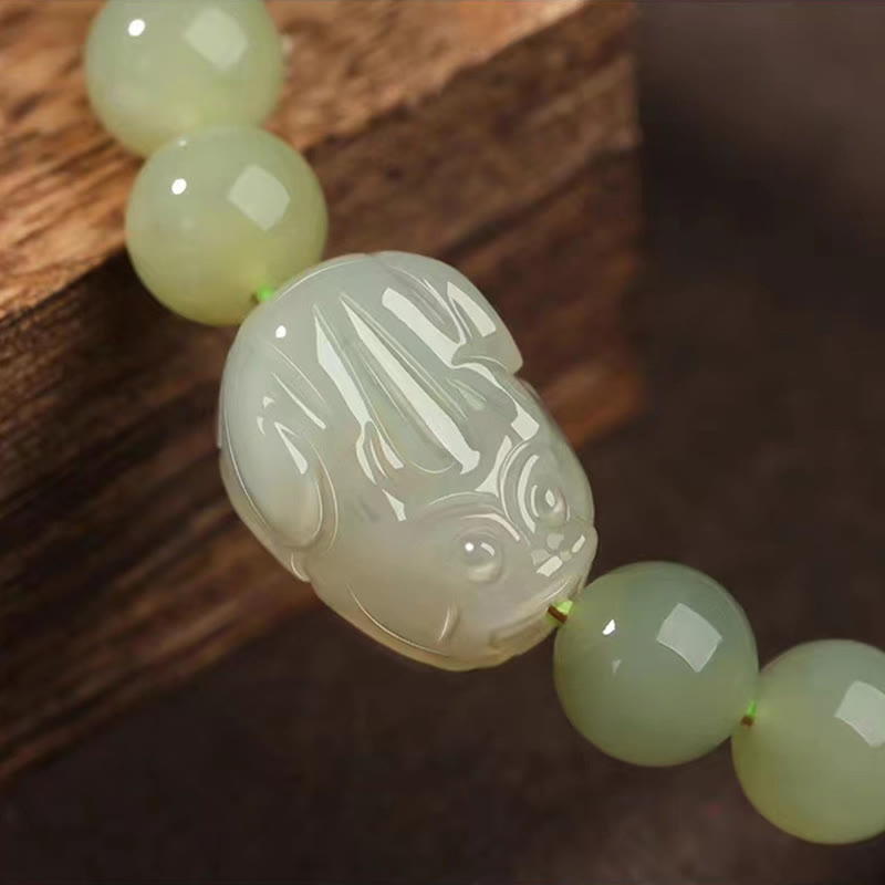 Hetian Jade PiXiu Bracelet – extreme close-up of carved PiXiu detail, translucent jade, artisan craft