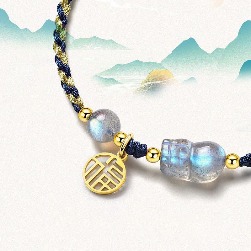 Moonstone PiXiu Tiger Eye Couple Bracelet – close-up moonstone PiXiu with moonstone bead gold Fu charm, mountain background