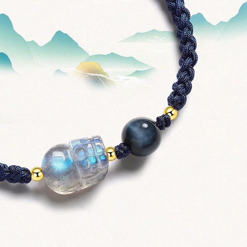 Moonstone PiXiu Tiger Eye Couple Bracelet – close-up moonstone PiXiu with blue tiger eye, mountain watercolor art background