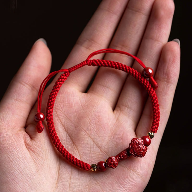 Cinnabar Ruyi Fu PiXiu Red Bracelet – Ruyi bracelet in woman's palm showing full adjustable design, gift ready
