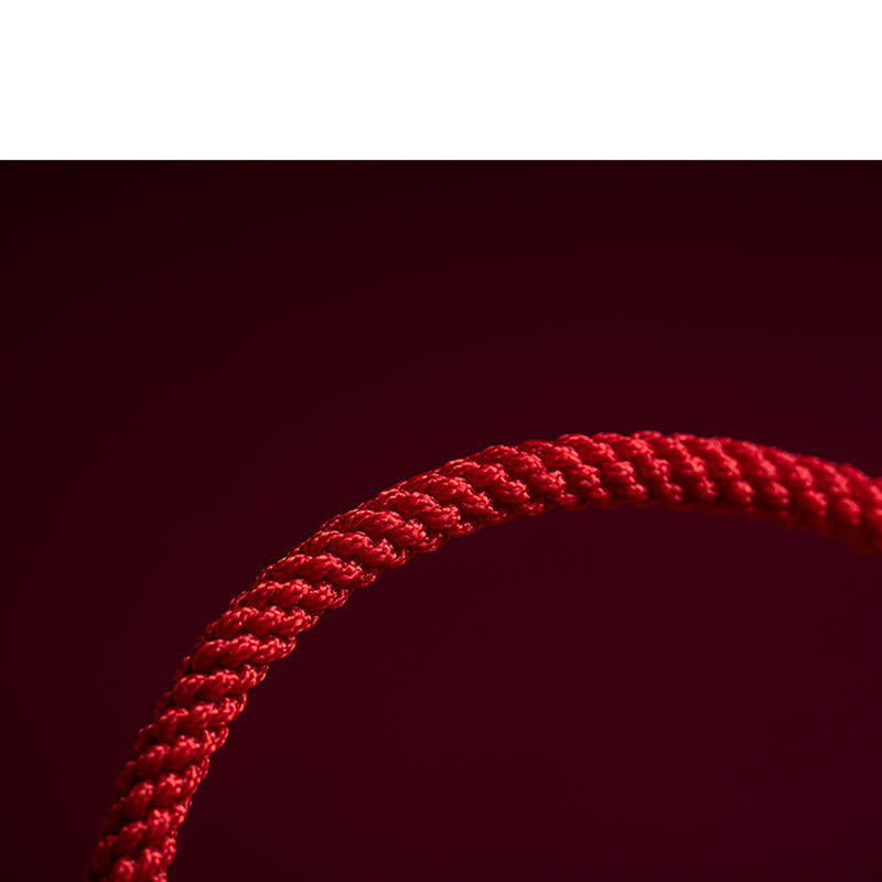 Cinnabar Ruyi Fu PiXiu Red Bracelet – extreme close-up red braided cord texture macro, handmade weave detail
