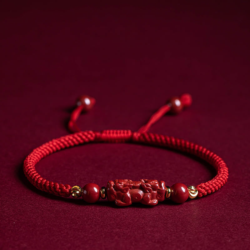 Cinnabar Ruyi Fu PiXiu Red Bracelet – PiXiu bracelet laid flat on red velvet front view, wealth mascot jewelry
