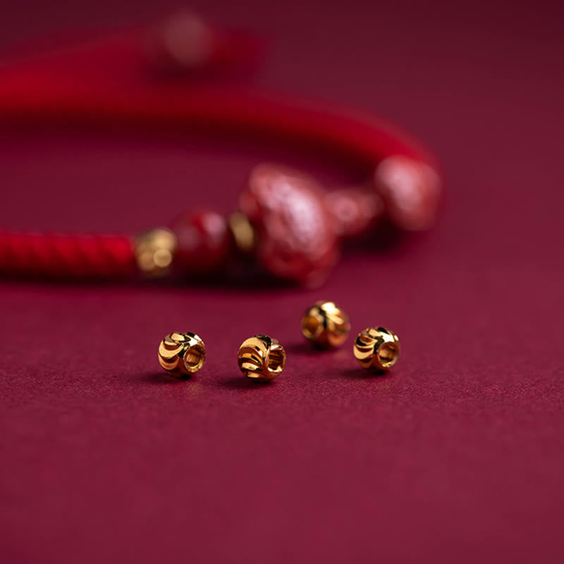 Cinnabar Ruyi Fu PiXiu Red Bracelet – close-up gold spacer beads with bracelet blurred, red velvet background