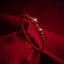 Cinnabar Ruyi Fu PiXiu Red Bracelet – single cinnabar Ruyi bracelet on red silk fabric, dramatic lighting, spiritual jewelry