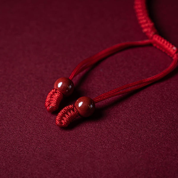 Cinnabar Ruyi Fu PiXiu Red Bracelet – adjustable cord ends with red beads on red velvet, bracelet closure detail