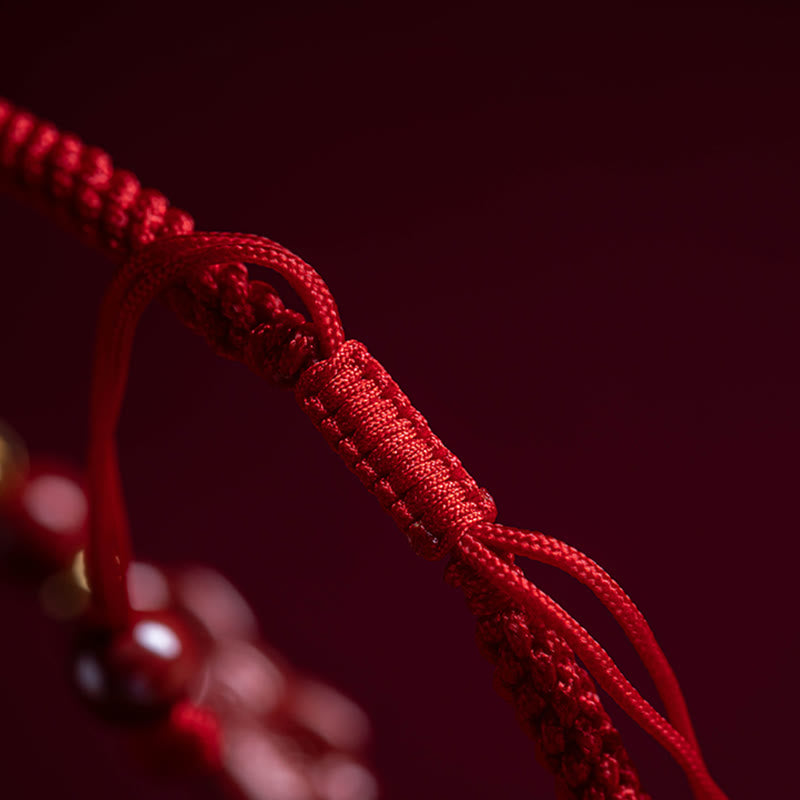 Cinnabar Ruyi Fu PiXiu Red Bracelet – extreme close-up red braided cord knot detail, craftsmanship macro shot