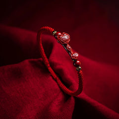 Cinnabar Ruyi Fu PiXiu Red Bracelet – single cinnabar Ruyi bracelet on red silk fabric, dramatic lighting, spiritual jewelry