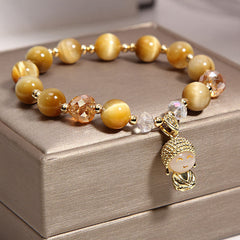 Yellow Tiger Eye Meditation Buddha Bracelet – On wrist showing chatoyant tiger eye shimmer, cat eye effect