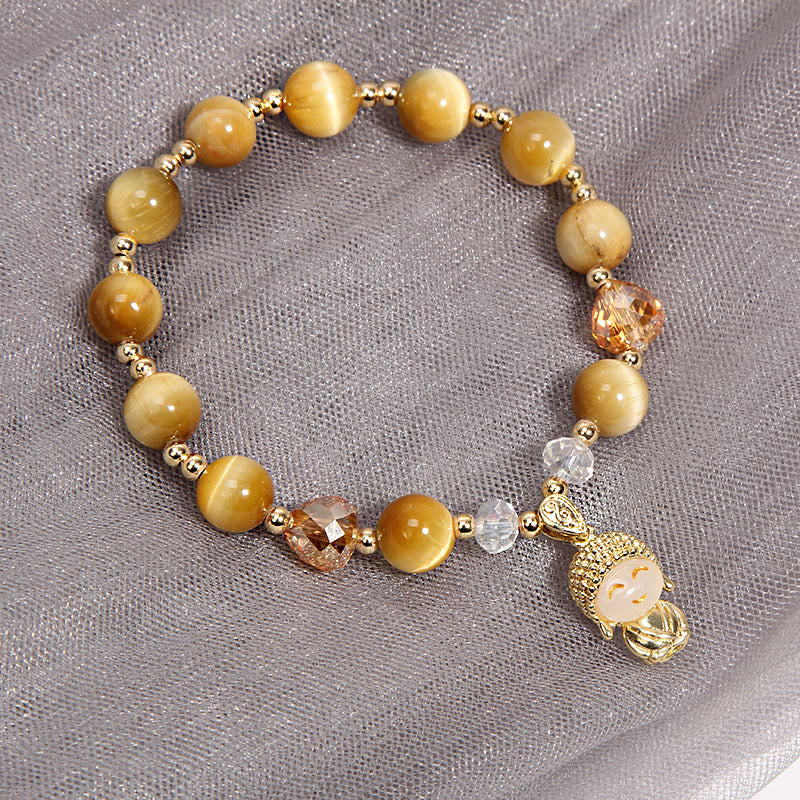 Yellow Tiger Eye Buddha Bracelet – flat lay on black slate showing bead pattern spacing