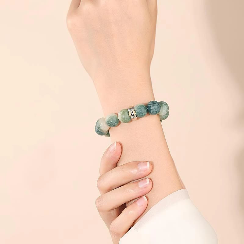 Chinese Zodiac Wisdom Bracelet – Worn on wrist showing carved green beads with silver mantra accent