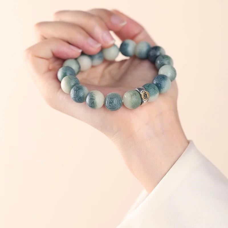 Chinese Zodiac Wisdom Bracelet – Teal and cream marbled beads on palm, carved cloud pattern bracelet