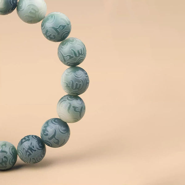 Chinese Zodiac Wisdom Bracelet – Close-up of carved stone beads in mint to teal gradient, mantra details