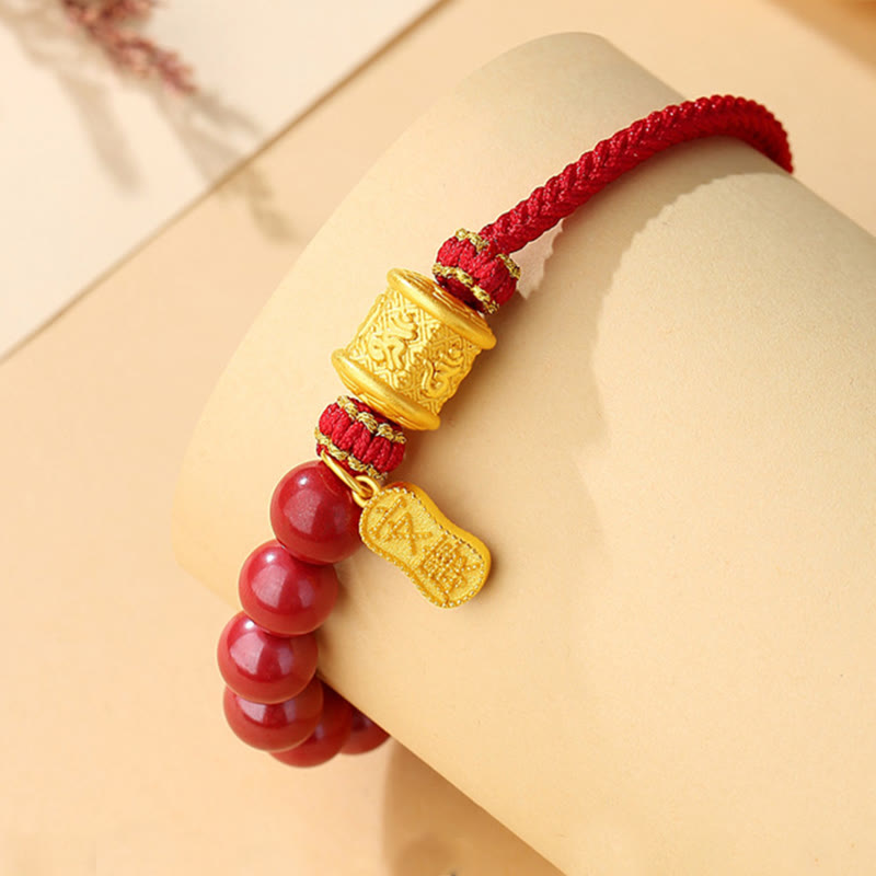 Sterling Silver Cinnabar Bracelet – Worn on mannequin wrist showing red beads and gold accents, adjustable cord bracelet