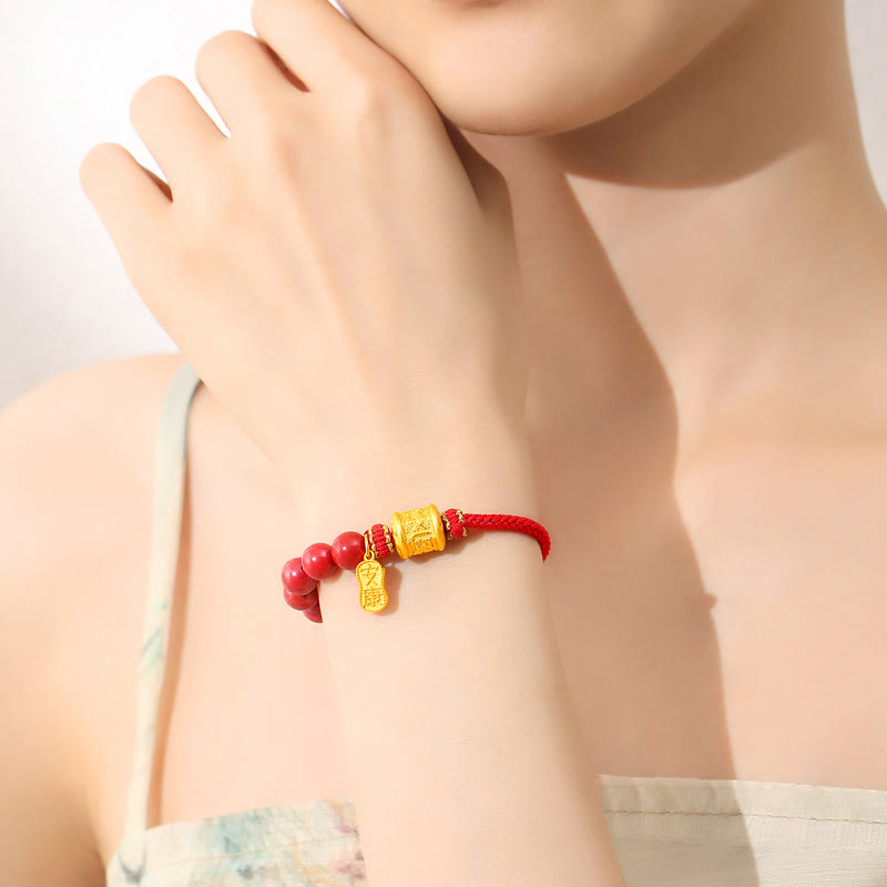 Sterling Silver Cinnabar Bracelet – Worn on wrist showing polished red cinnabar beads with gold pendant, spiritual jewelry