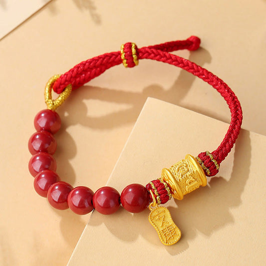 Sterling Silver Cinnabar Bracelet – Close-up of red cinnabar beads with engraved gold barrel charm, lucky red bracelet