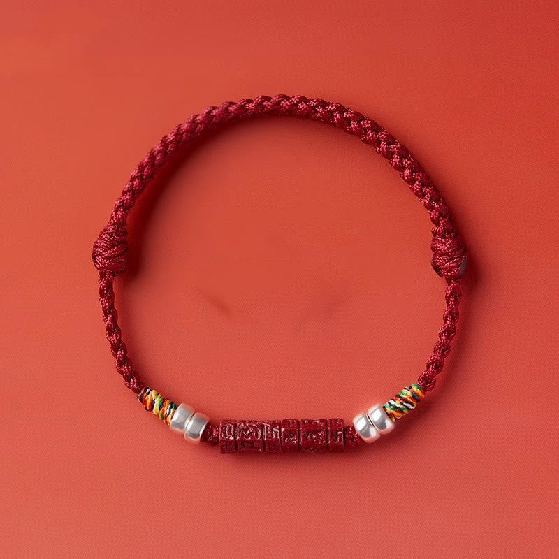 Cinnabar Om Mani Padme Hum Red String Bracelet – warm red backdrop flat lay, spiritual wristwear