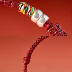 Cinnabar Om Mani Padme Hum Red String Bracelet – macro of silver beads and multicolor thread, craftsmanship