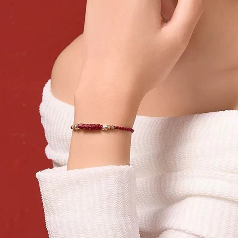 Cinnabar Om Mani Padme Hum Red String Bracelet – wrist styling on red background, protection bracelet