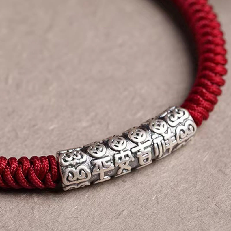 Silver Mantra Rope Bracelet – Macro detail of silver bead with Chinese characters and cloud motifs, peace charm